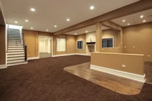 Spacious multi-zone finished basement with carpet, wood flooring, and fireplace feature. Professional Legal Basement Finishing Barrie by YAM Home Renovation.