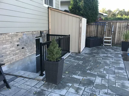 Modern side entrance and egress window by YAM Home Renovation.